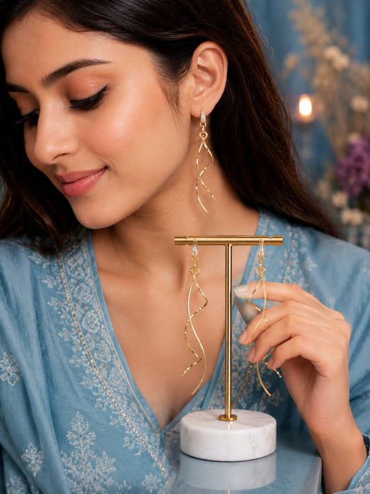 Model in a blue chikankari kurta wearing long gold-plated spiral drop earrings