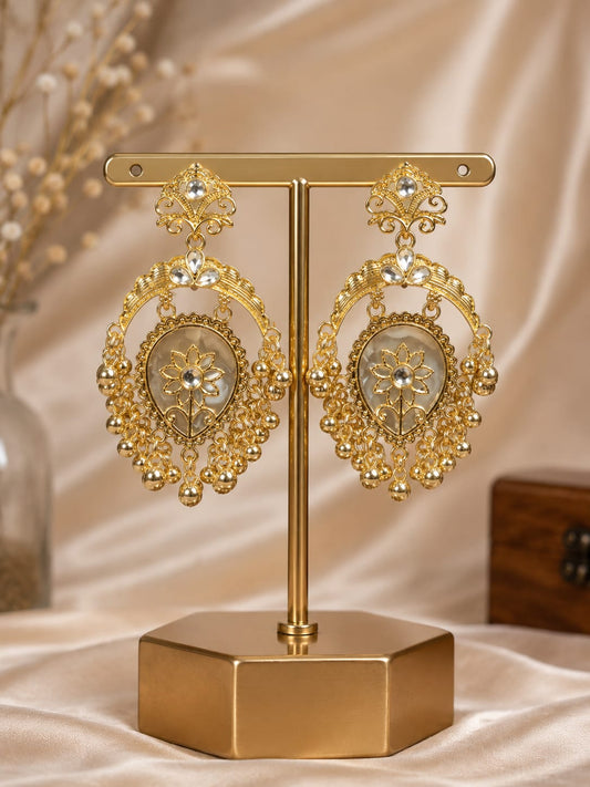 Gold-plated crescent chandbali earrings with an ivory shell teardrop centre and gold bead fringe on a gold stand