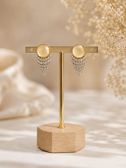Gold-plated stud earrings with a yellow cat's-eye cabochon and a chevron fringe of clear crystals