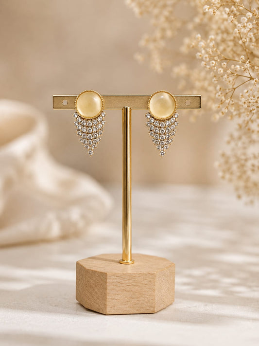 Gold-plated stud earrings with a yellow cat's-eye cabochon and a chevron fringe of clear crystals
