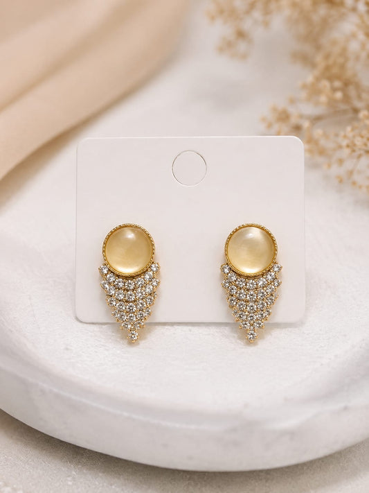 Pair of yellow cat's-eye crystal fringe stud earrings on a white presentation card