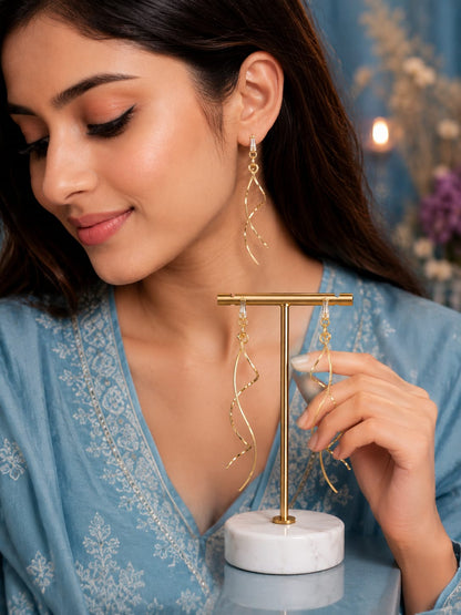 Model in a blue chikankari kurta wearing long gold-plated spiral drop earrings