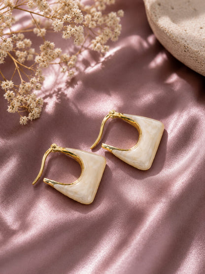 Ivory marbled resin square hoop earrings with a gold-plated frame on pink satin