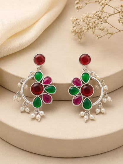 Pair of silver crescent chandbali earrings with ruby and emerald petals and white pearl drops