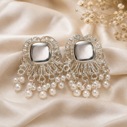 Silver-tone stud earrings with a domed cushion stone in a scalloped filigree fan and faux pearl fringe on ivory satin