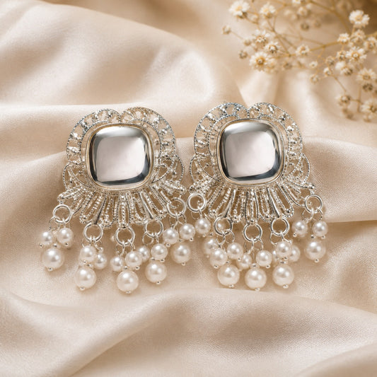 Silver-tone stud earrings with a domed cushion stone in a scalloped filigree fan and faux pearl fringe on ivory satin