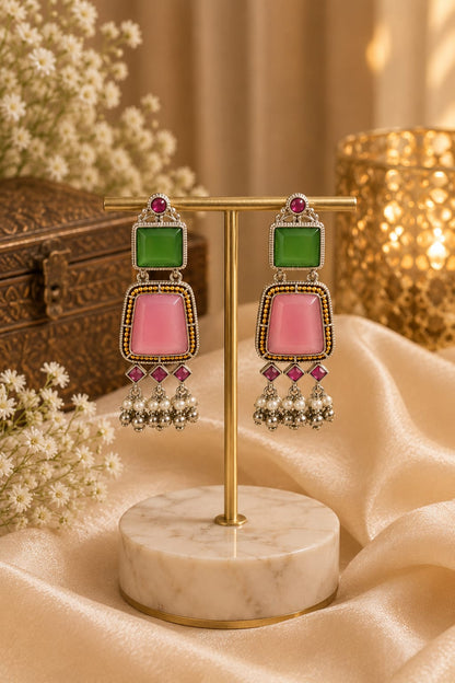 Oxidised silver drop earrings with a green square stone, rose pink trapezoid stone and pearl fringe